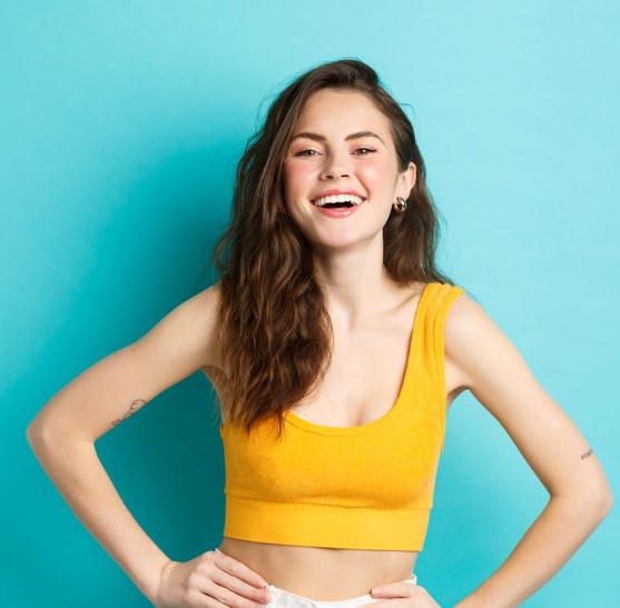 bella mujer de cabello castaño posando una piel joven y radiante gracias a un tratamiento de electrolifting